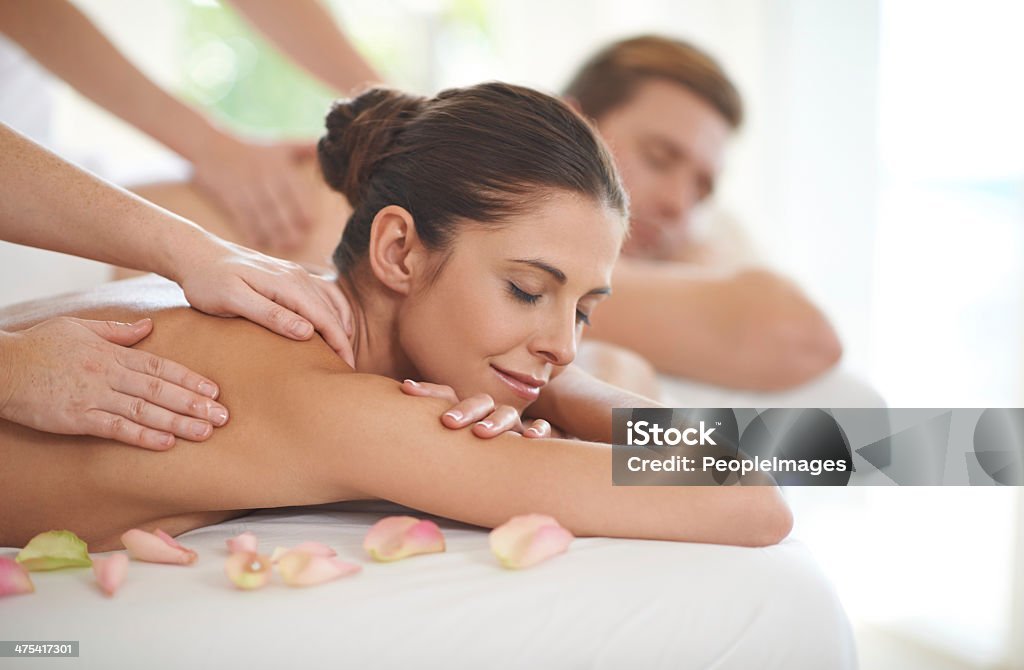 A woman receiving a body massage, reflecting relaxation and self-care as part of a fitness routine. 