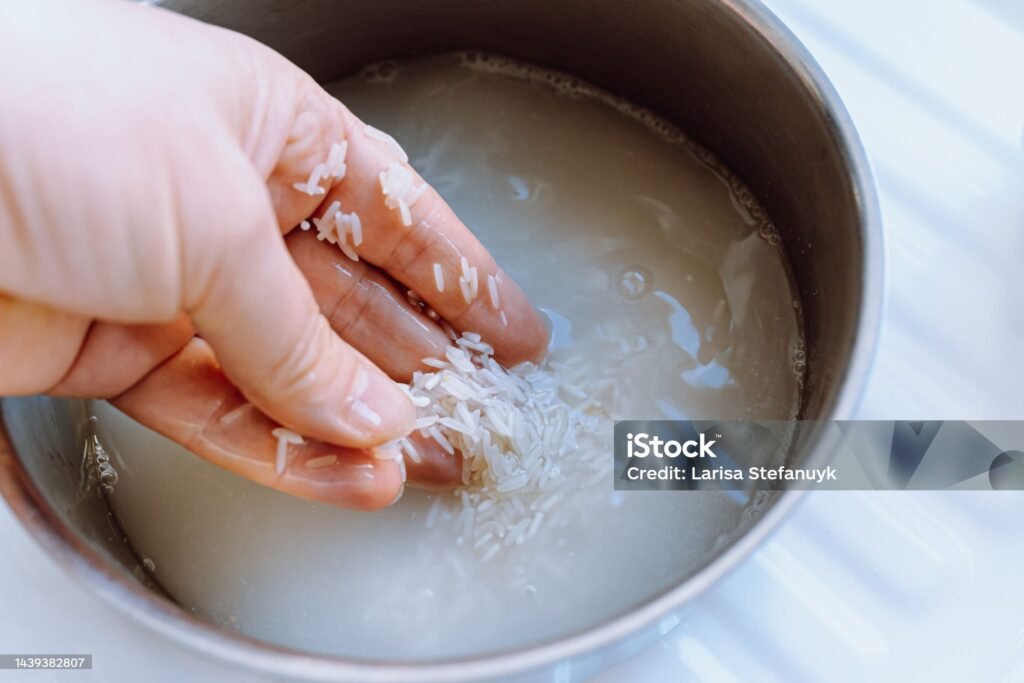 Bowl of rice with water being poured, illustrating Japanese rice water skincare and global skincare secrets.