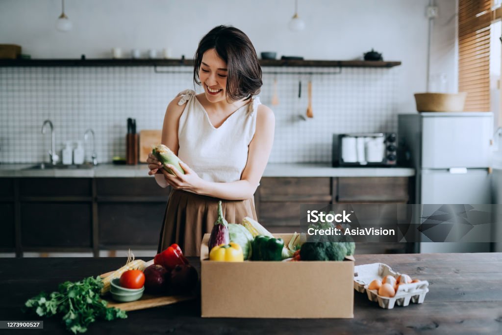 Cook More Meals at Home: The Secret Ingredient to Healthy Eating and Weight Loss - Woman preparing a healthy meal in her kitchen.