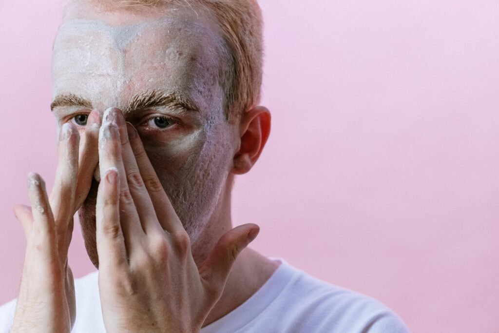 Man applying moisturizer to his face to keep his skin hydrated and healthy