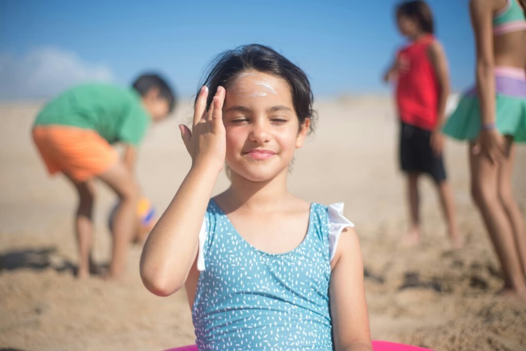 Applying sunscreen daily to protect skin from UV rays, following essential clear skin care tips.