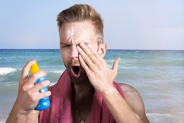 Man applying sunscreen to protect his skin from sun damage as part of his skincare routine.