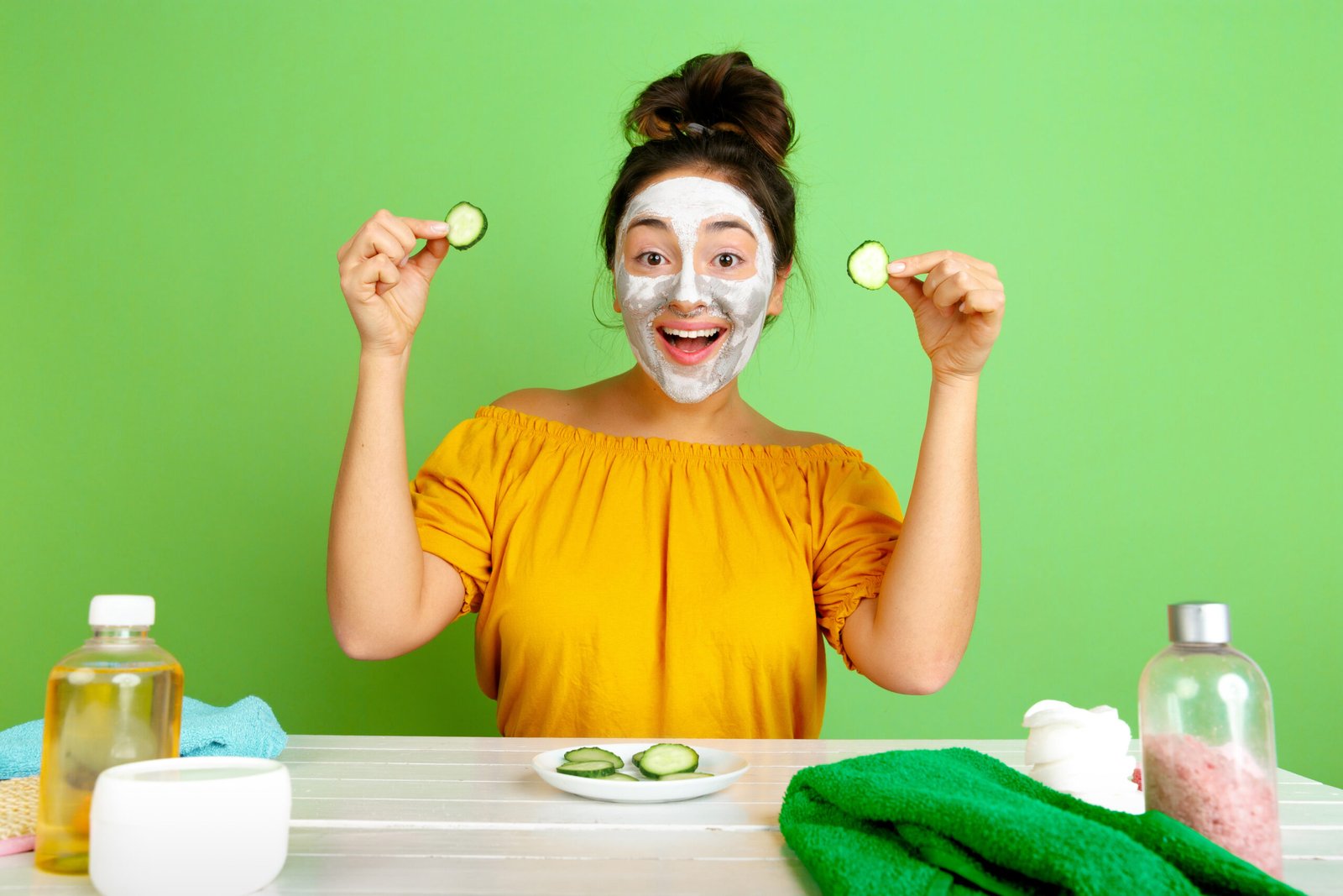 A woman applying a homemade face mask for clear skin, showcasing natural skincare remedies for a glowing complexion.